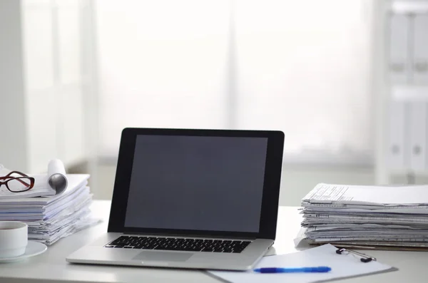 Office desk a stack of computer paper reports work forms