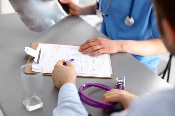 Family doctor spends consultation in the office