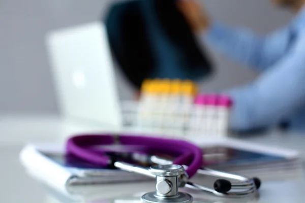 Medical doctor sitting at table and looking patients roentgen