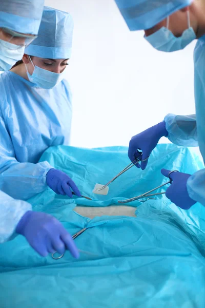 Team of surgeon in uniform perform operation on a patient at cardiac surgery clinic