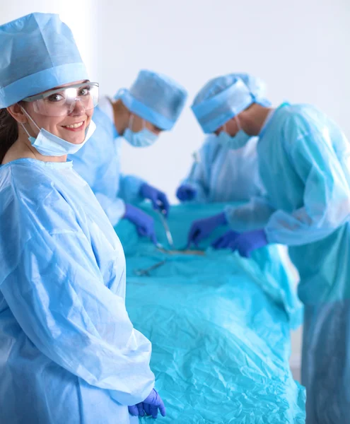Team of surgeon in uniform perform operation on a patient at cardiac surgery clinic