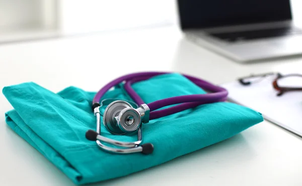 Doctor clothes lying on the table with a stethoscope