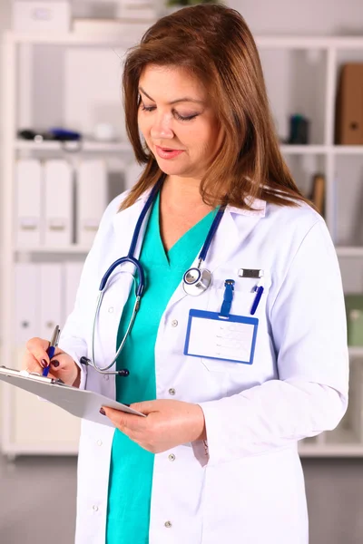 Portrait of happy medical doctor woman in office