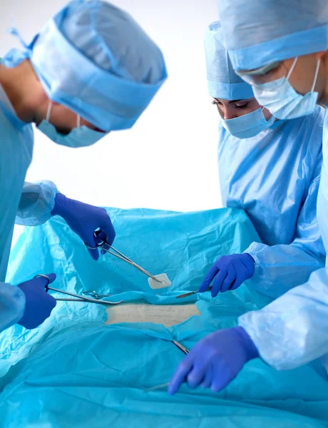 Team of surgeon in uniform perform operation on a patient at cardiac surgery clinic