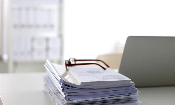 Office desk a stack of computer paper reports work forms