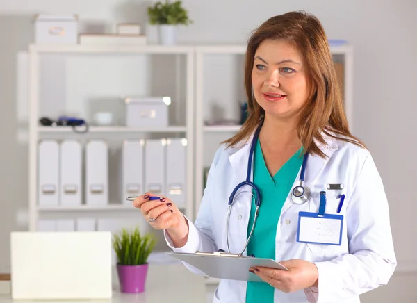 Portrait of happy medical doctor woman in office