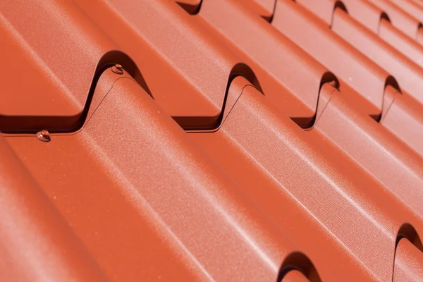 Red metal tile with screw