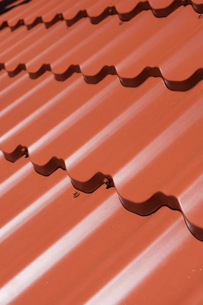 Red metal tile with screw