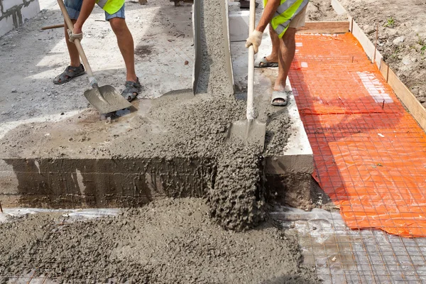 Mixed concrete pouring at construction site