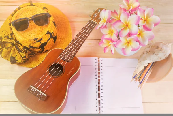 Summer mood background ukulele on blank note book