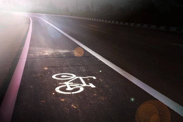 Bicycle sign on bike lane at new paved road, bicycle symbol on street