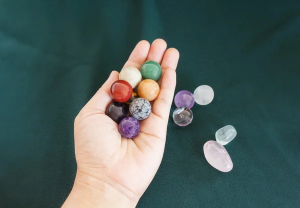 Colourful round stones in hand, quartz