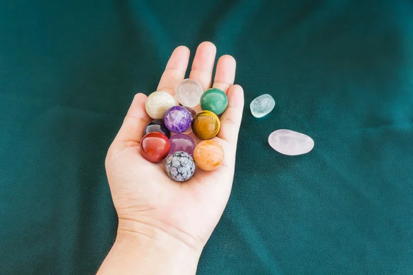 Colourful round stones in hand, quartz