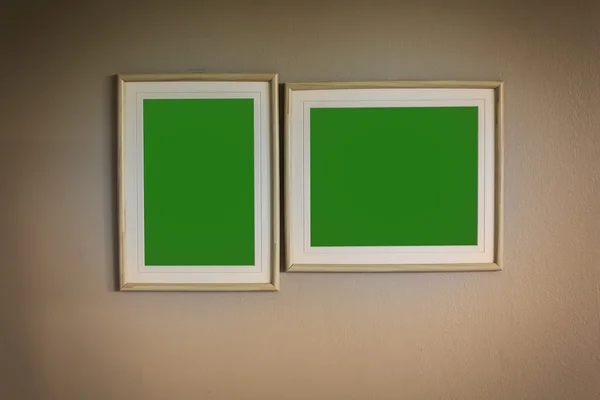 Blank picture green screen wooden frame on the wall