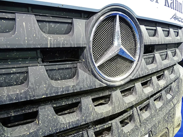 Muddy front end of a truck of the type Mercedes-Benz Arocs