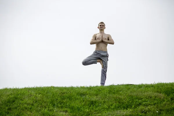 Man doing yoga exercises in the park