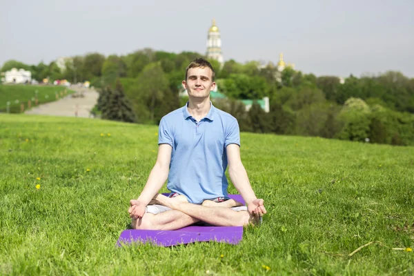 Man doing yoga exercises in the park