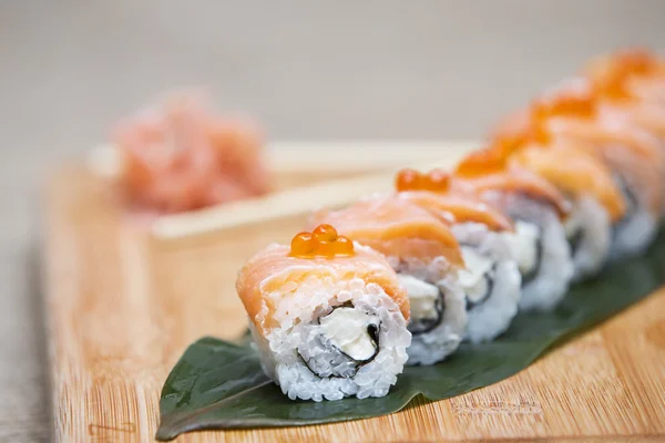 Uramaki. Philadelphia classic. Salmon, Philadelphia cheese, cucumber, avocado, tobiko. Japanese sushi. sushi rolls with ginger and soy sauce.