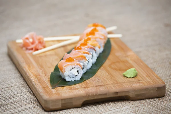 Uramaki. Philadelphia classic. Salmon, Philadelphia cheese, cucumber, avocado, tobiko. Japanese sushi. sushi rolls with ginger and soy sauce.