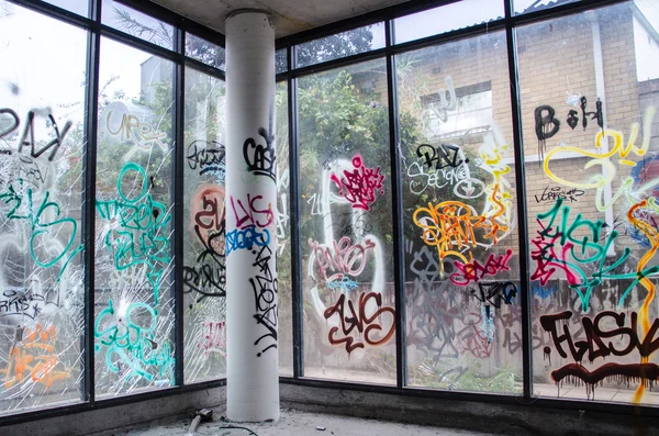 Graffiti covered Window in an Abandon Building - Stock Photo