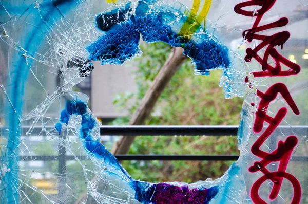 Smashed Graffiti covered Window in an Abandon Building - Stock Photo