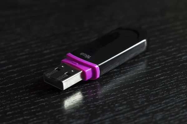 USB flash drive on a black office desk