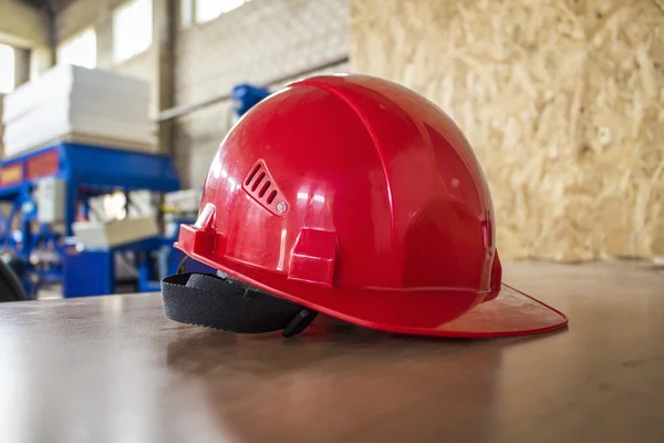 Red hard hat on a table.