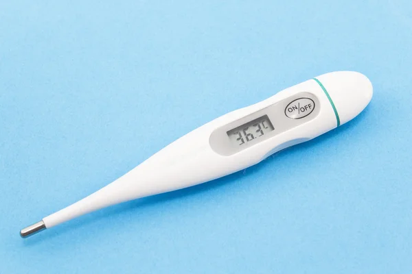 Digital thermometer on a blue background