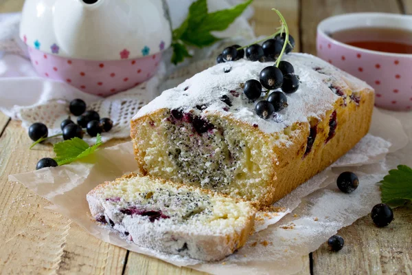 Homemade cake with black currant with icing sugar and fresh berr