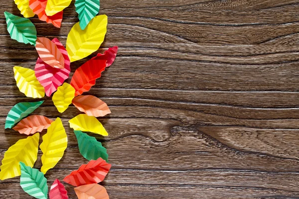 Autumn leaves background of colorful origami paper leaves. Brown