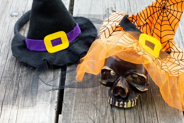 Objects decoration Halloween hat and skull on a wooden table