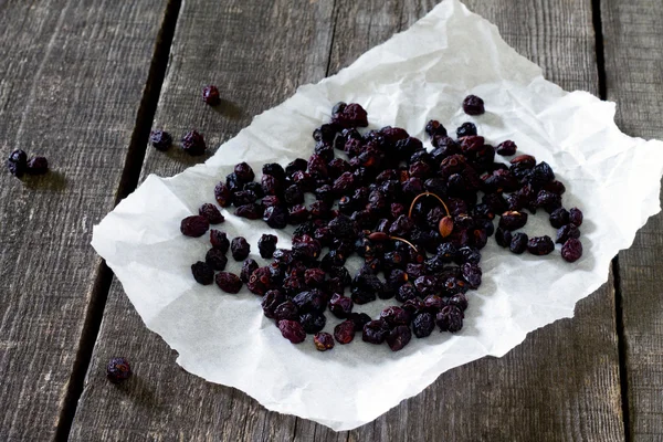 Dried fruits: dried cherries on a dark wooden background.