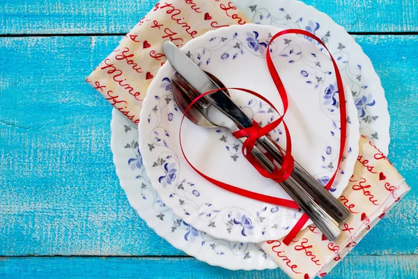 Romantic table setting for Valentine\'s Day on wooden table.