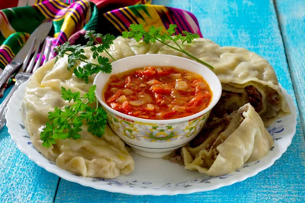 Khanum with potatoes and meat and tomato sauce, lazy dumplings o