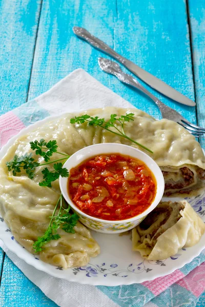 Khanum with potatoes and meat and tomato sauce, lazy dumplings o