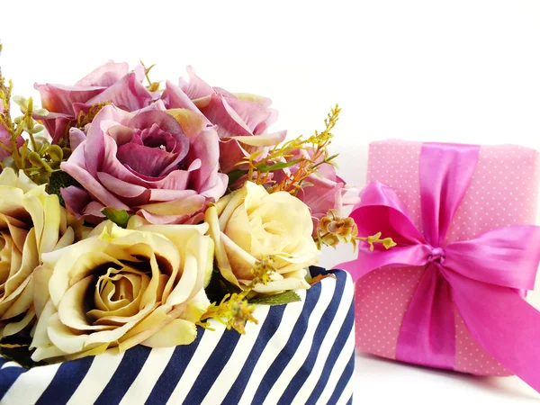 Present gift box and flowers artificial bouquet on white background