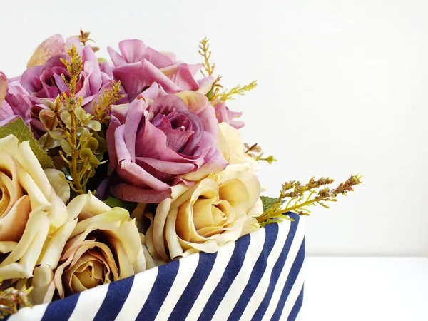 Present gift box and flowers artificial bouquet on white background