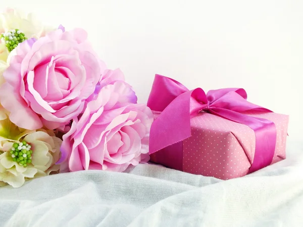 Gift box present with artificial flowers for mothers day