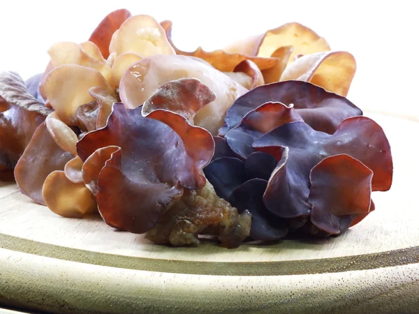 Black fungus jelly ear on wooden cutting board