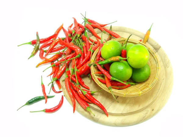Lime and red chillies isolated on white