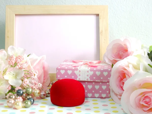 Blank photo wood frame with pink roses and gift box on sweet flower