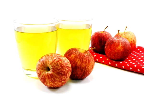 Red apples and glass of fresh apple juice over white background