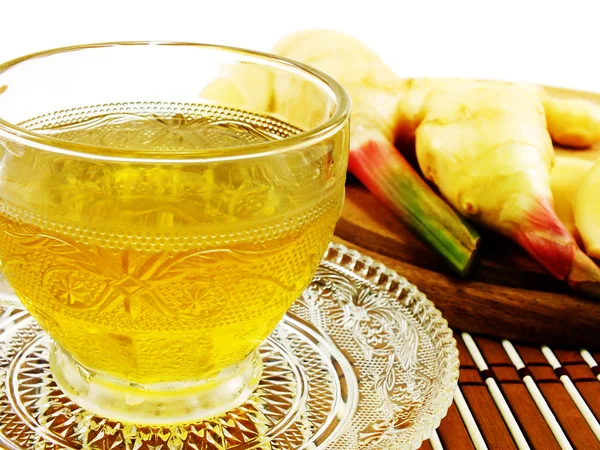 Ginger tea and ginger root on a wooden background