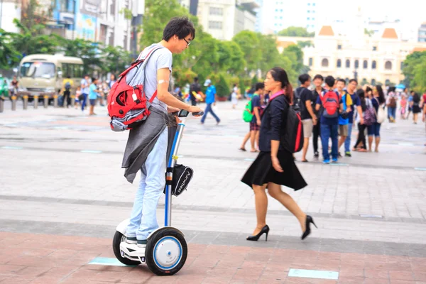 Hochiminh City, Vietnam - July 8, 2015: Man riding a Segway electric vehicle two wheels on a young tour sightseeing gyropode on Walking Street Nguyen Hue Street, HoChiMinh city center