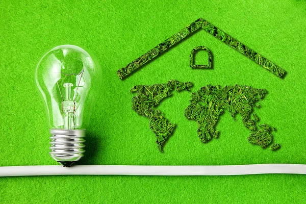 Concept ecology. Green house. Light bulb and world map component of the walls of the house  isolated on green background