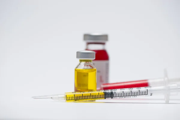 Medical ampules with syringe isolated on white background
