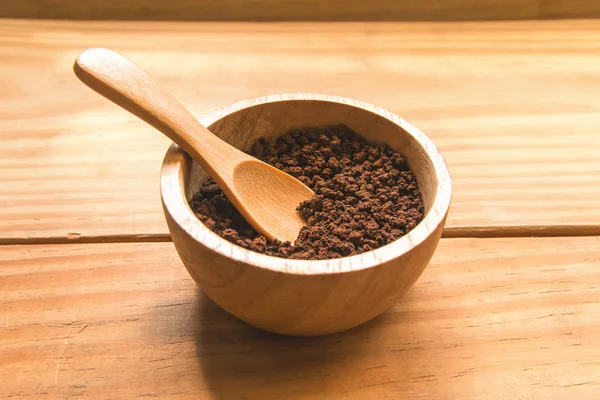 Instant coffee in wood bowl with wood spoon