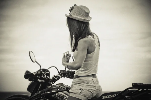 Girl on motorcycle, sepia effect