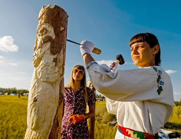 Girl making wooden sculpture