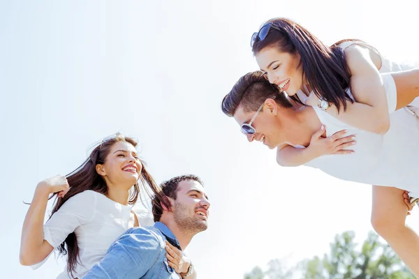 Happy people carrying women on beach